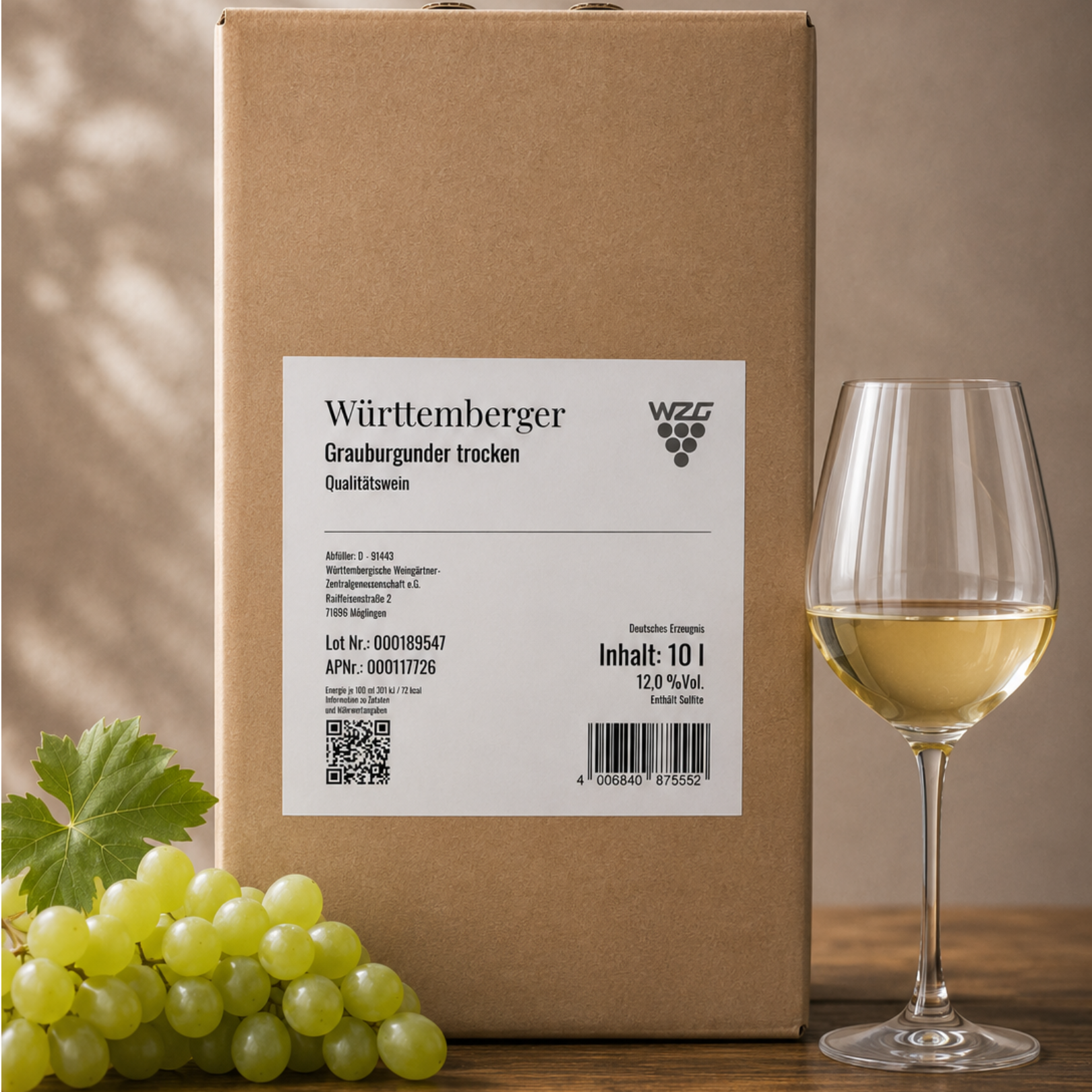 Württemberger Grauburgunder trocken im 10 Liter Bag in Box mit Weißweinglas und hellen Weintrauben auf einem Holztisch.